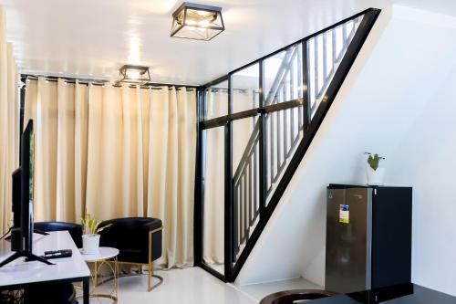 an office with a staircase and a desk with a computer at MilGees Vacation House in Cagayan de Oro
