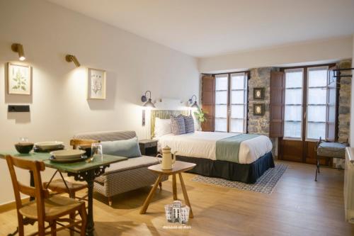 a hotel room with a bed and a table at Morada de Mar apartamentos in Ribadesella
