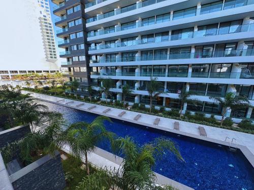 an apartment building with a swimming pool and palm trees at Grand Sapphire Residence By Aircyp in Iskele