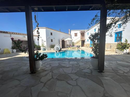 a courtyard with a swimming pool in a house at Little Stone House in Lymbia