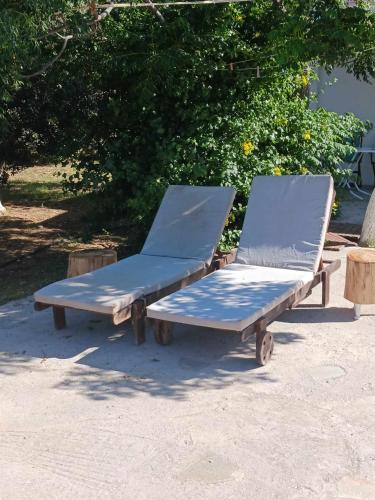 two beds sitting next to each other on the ground at Ακροδεα in Áno Gávrion