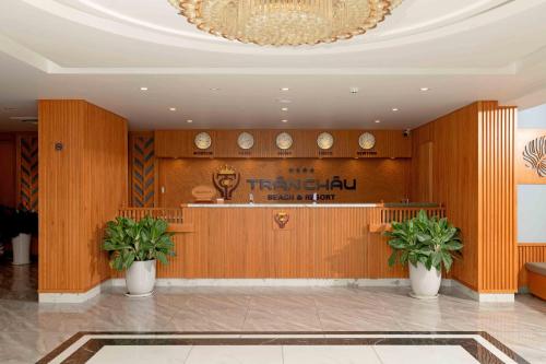 a lobby of a hotel with a bar and a chandelier at Trân Châu Beach & Resort in Ba Ria
