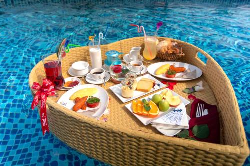 a table with food and drinks in a swimming pool at Trân Châu Beach & Resort in Ba Ria