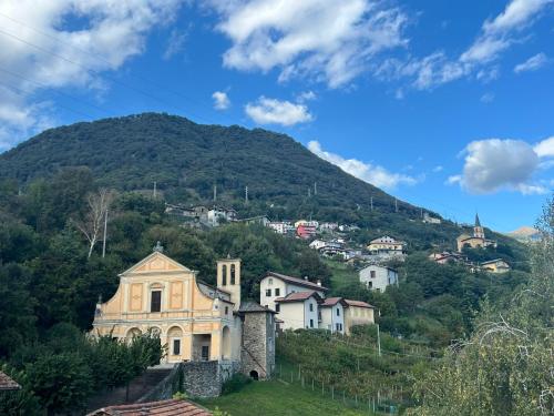 a village on a hill with a mountain in the background at Casa Nonna Nina in Vercana