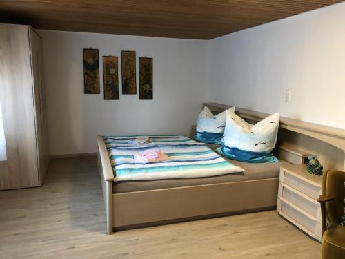 a bedroom with a bed with pillows on it at Haus Ahkamp in Hemmoor