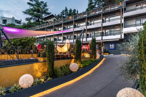 an exterior view of a building with a walkway at Hi Hotels Trento - Wellness & Spa Adults Only in Trento