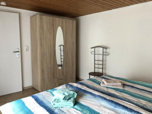a bedroom with a bed and a wooden door at Haus Ahkamp in Hemmoor