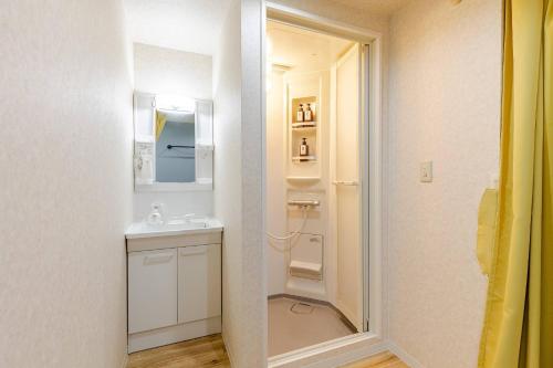 a small bathroom with a sink and a mirror at DS Dotonbori II 3F DD3 in Osaka
