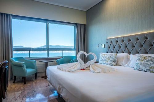 a hotel room with a bed with a heart on it at Hotel Bahía de Vigo in Vigo