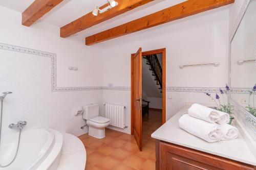 a bathroom with a toilet and a sink at Villa Pedra Vista by Sealand Villas in El Port