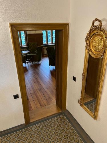 a hallway with a mirror and a dining room at Villa Märchenland in Kurort Altenberg