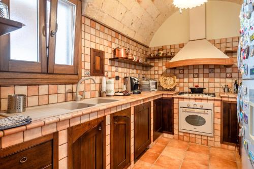 a kitchen with a sink and a stove at Dimora La Reggia in Mesagne