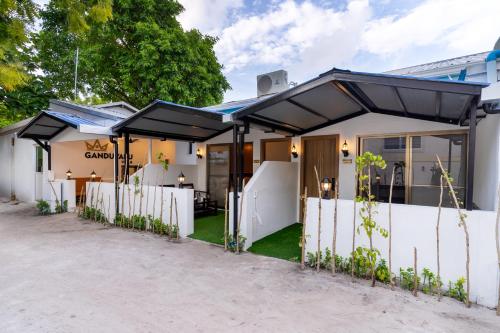 a house with black umbrellas in front of it at Ganduvaru Villa in Ukulhas