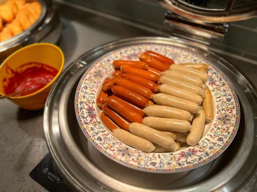 a plate of hot dogs and carrots on a table at Guangzhou Southern Airlines Pearl Airport Hotel- Free shuttle bus to airport in Guangzhou