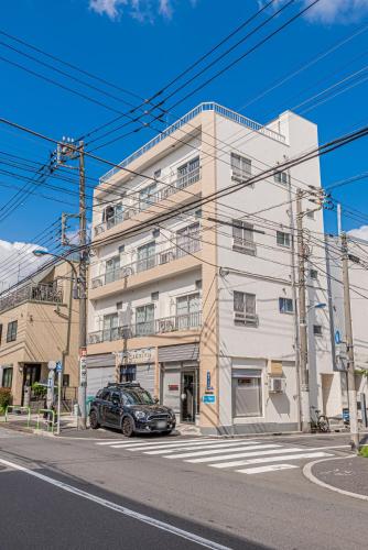 a car parked in front of a building at mori house西が丘 in Tokyo