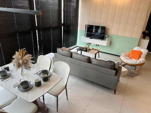 a living room with a couch and a table at High Floor, 3BR 3queen bed, 2 parking, Urban Suites by XWHome in Jelutong