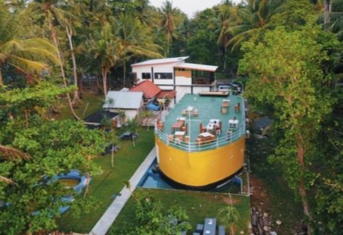 a large boat sitting in front of a house at Krui Ocean in Krui