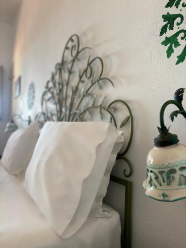 a white vase sitting on top of a bed at Villa La Rosa in Filicudi