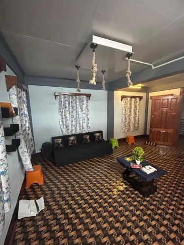 a living room with a couch and a table at Serenity Homestay Shillong in Shillong