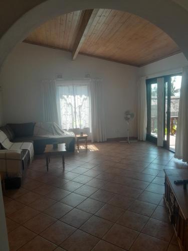 a living room with a couch and a table at Bed on 22 in Ballito