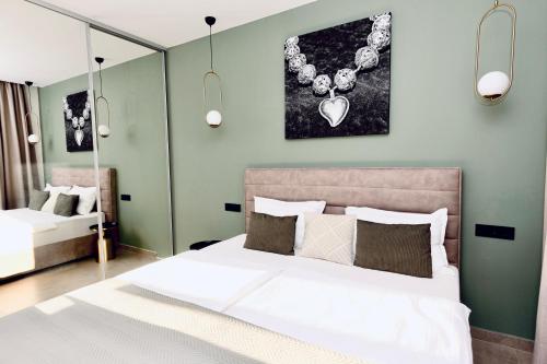 a bedroom with a large bed and a mirror at Villa Barovic - Delux Apartment in Mlini