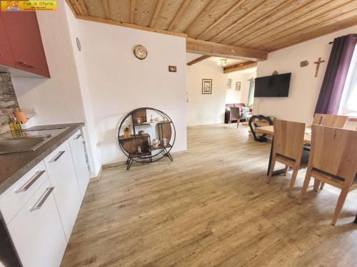 a kitchen and living room with a table and chairs at Apartment Bühemirla by FiS - Fun in Styria in Altaussee