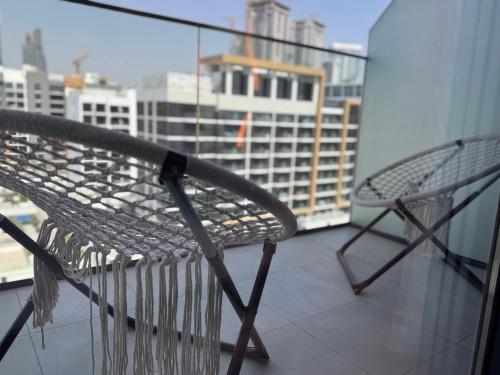 a bench on a balcony with a view of a city at Ashri Elegant Studio Near Burj Khalifa in Dubai