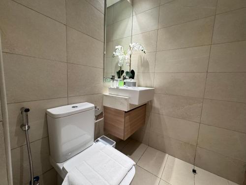 a bathroom with a white toilet and a sink at Ashri Elegant Studio Near Burj Khalifa in Dubai