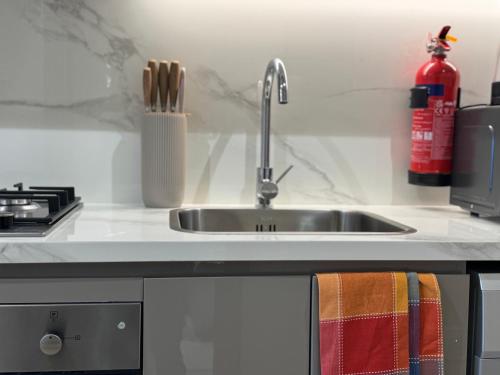 a kitchen counter with a sink and a stove at Ashri Elegant Studio Near Burj Khalifa in Dubai