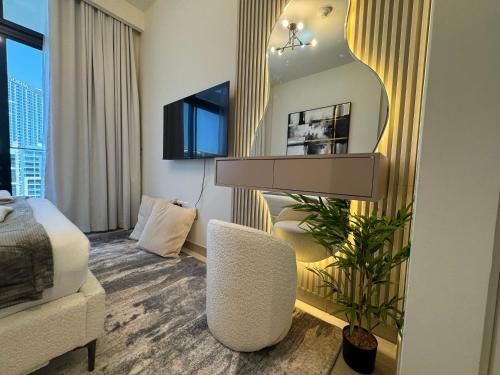 a hotel room with a bed and a chair and a mirror at Ashri Elegant Studio Near Burj Khalifa in Dubai