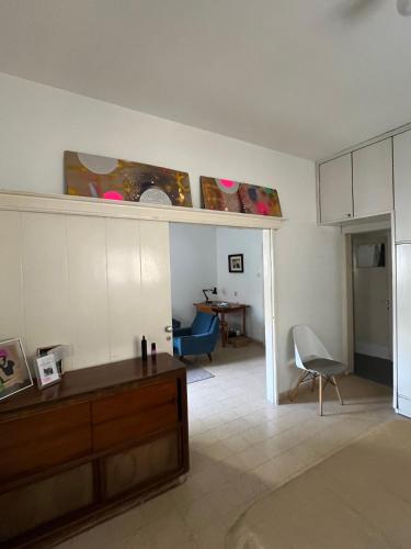 a living room with a table and a dining room at Tel-Aviv Vibe Apartment in Tel Aviv