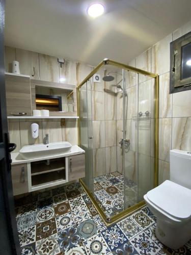 a bathroom with a shower and a toilet and a sink at Ayder Villa Gencal in Ayder Yaylasi