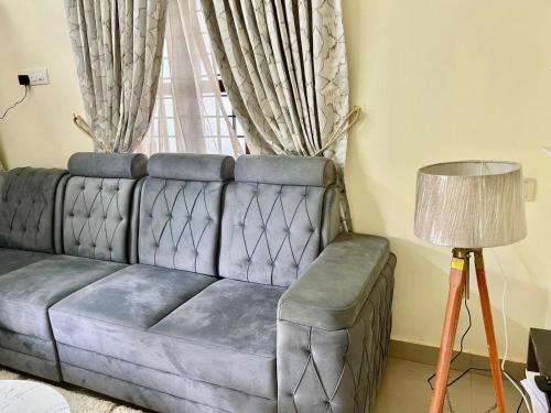 a couch in a living room with a window at Krishnakripa - Luxury Private Villa Near Guruvayoor Temple in Guruvāyūr