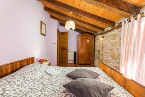 a bedroom with a bed with a laptop on it at Villa Stari Dor in Heki