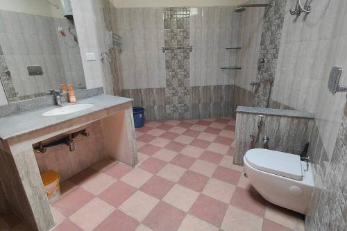 a bathroom with a toilet and a sink and a shower at Basti House - Boutique Homestay in Lucknow