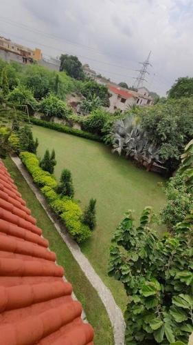 an aerial view of a green yard with houses at Basti House - Boutique Homestay in Lucknow