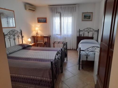 Postel nebo postele na pokoji v ubytování Bed&Breakfast L'Oasi