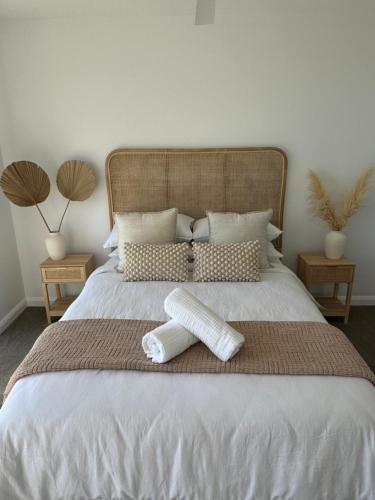 a bed with two pillows and a blanket on it at Sunshine Coast Paradise in Maroochydore
