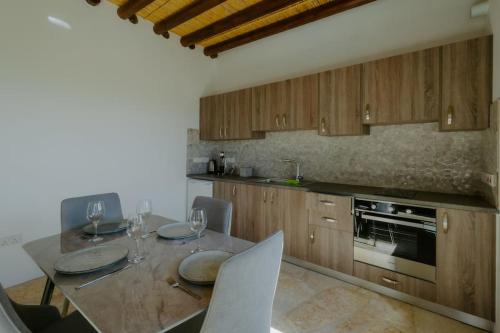a kitchen with a table with plates and wine glasses at Dipaton House in Vasa 1 in Limassol