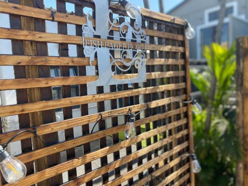 a wooden fence with lights and a sign on it at Fish Eagle Place in Durban