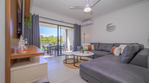 a living room with a couch and a table at Ballito Village Luxury Apartments in Ballito