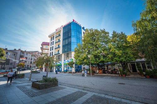 a tall blue building on a city street at Monelly apartments Loznica - pešačka zona in Loznica