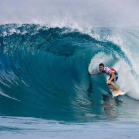 a man riding a wave on a surfboard in the ocean at Krui Ocean in Krui