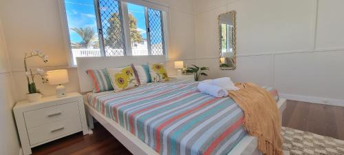 a bedroom with a bed with two stuffed animals on it at The Heavenly Haven in Brisbane