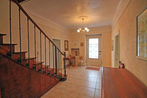 a hallway with a staircase in a home at Les Hirondelles in Villemain