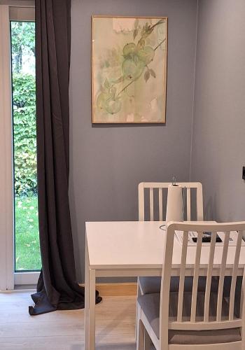 a dining room with a table and two chairs at EngholmBB in Odense