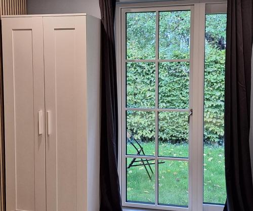 a window with black curtains next to a door at EngholmBB in Odense