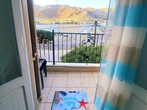 a room with a view of a balcony with a window at Faros studios Kalymnos Lighthouse in Kalymnos