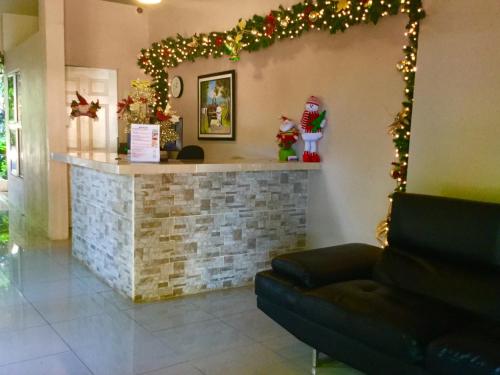 a living room with a fireplace with christmas lights at Hotel y Apartments Los Cisneros in Managua