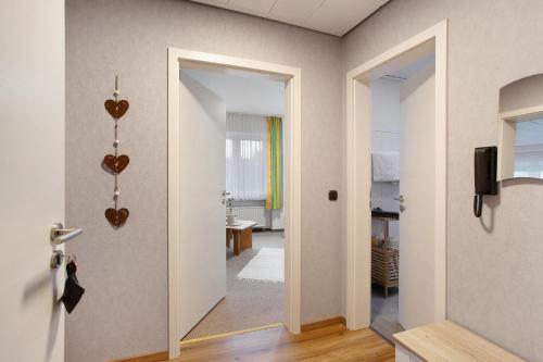 a hallway with a door with hearts on the wall at Birkenhauer inkl Meine Card plus in Willingen